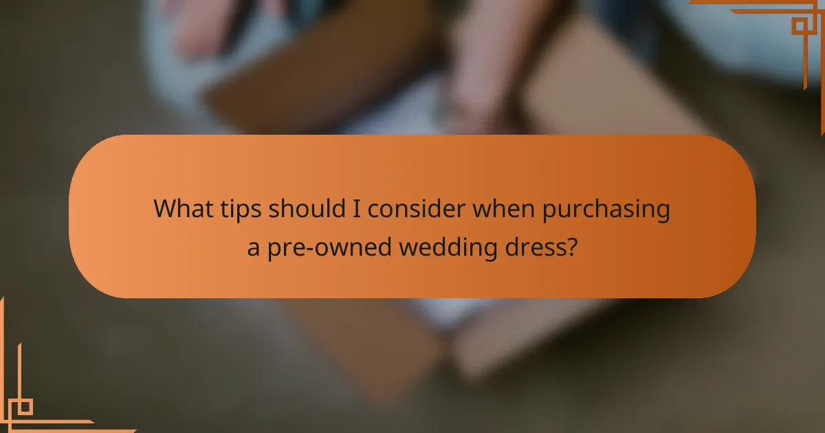 What tips should I consider when purchasing a pre-owned wedding dress?